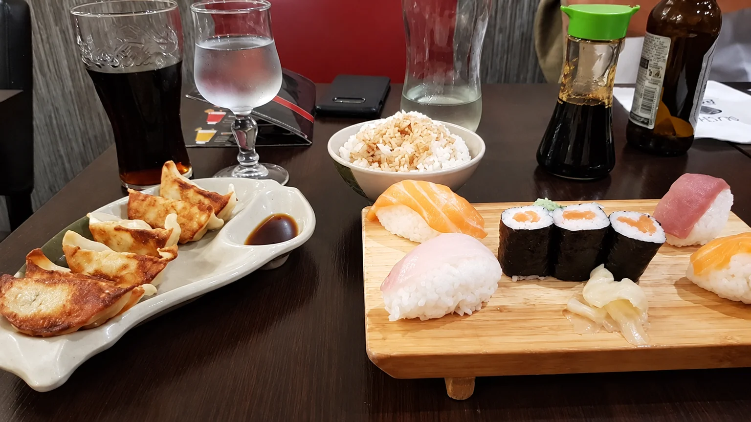 Sushi and dumplings on a dark table