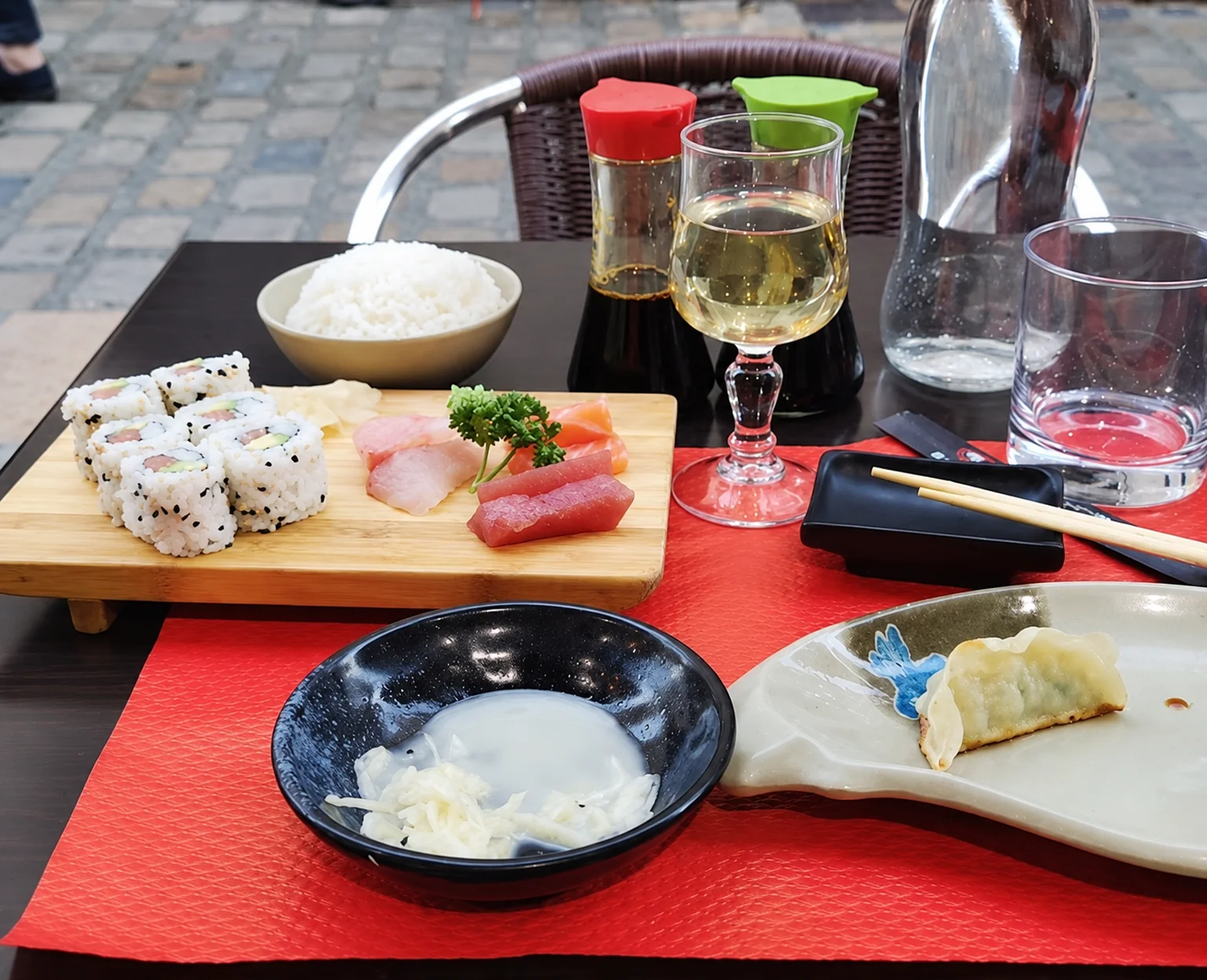 Maki and sashimi on a red table